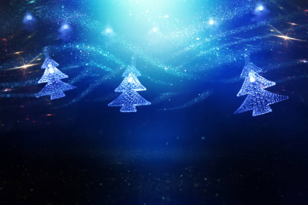 Christmas tree garland lights over dark background with glitter overlay