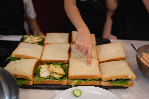 istock close-up shot. hands holding fresh chicken toast at cooking classes 1444888337
