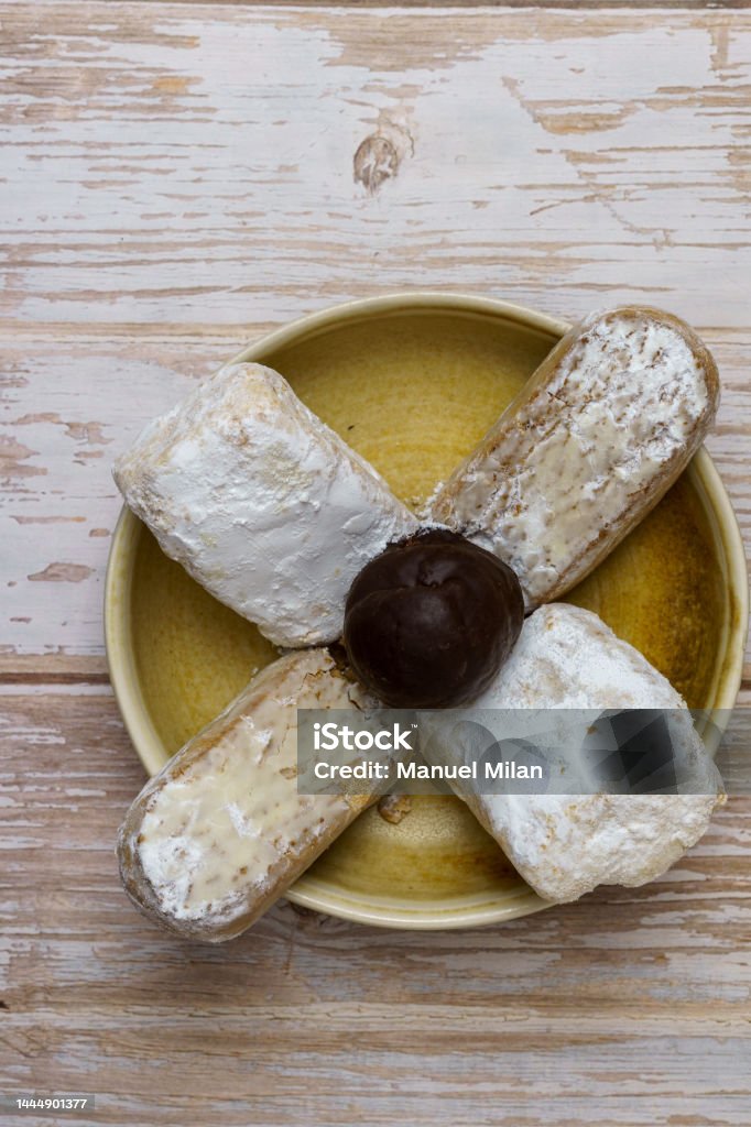 Polvorones and mantecados, traditional Christmas cakes from Andalusia, Spain, on wooden background, view from above. Copy space Affectionate Stock Photo