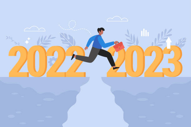 istock New Year 2023 resolutions, opportunity and hope for success  business concept.  Modern vector illustration of business man jumping over cliff gap from 2022 to 2023 1444902408