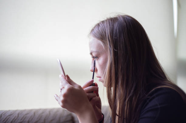 istock Blonde girl is doing makeup. 1444903826