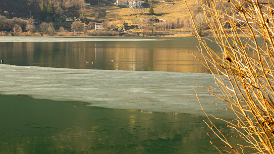 Lake Endine, Bergamo, Italy. Amazing view of the lake in winter time. Partially frozen lake. Ice covering part of the lake