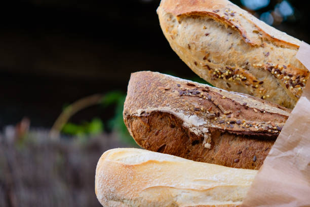 istock Three French multi-grain baguettes in a paper package. Copy space. 1444906492