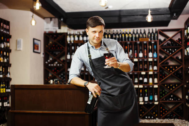 istock Male sommelier tasting red wine in cellar. Professional degustation expert 1444908469