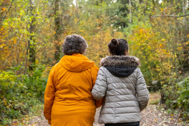 istock Mature mother and daughter walking in a park 1444910040