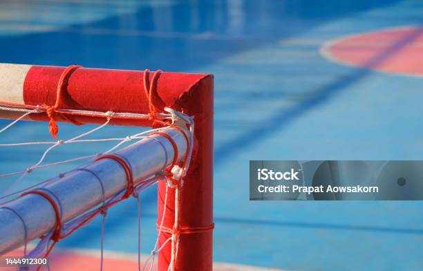 Focus At Top Right Corner Of Red And White Soccer Goal Crossbar With Blurred Background Of Outdoor Futsal Court Stock Photo - Download Image Now