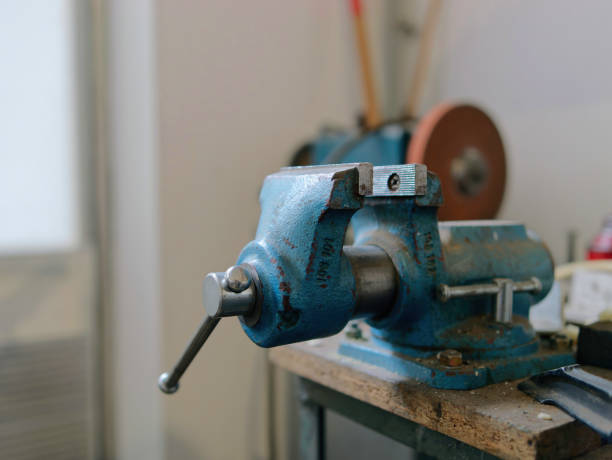 istock Selective focus shot of a blue bench vice on the workbench in a mechanical workshop 1444912412