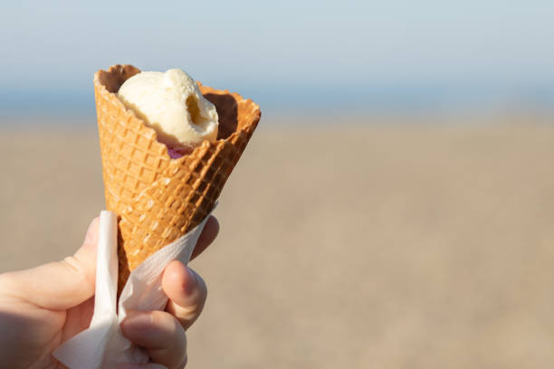 istock hand with ice cream in a waffle cone, gelato, summer dessert 1444914353