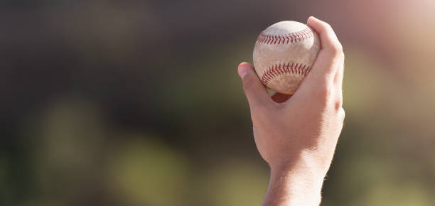 istock Male hand holding baseball ball 1444916605
