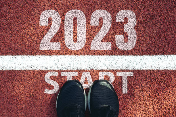 start 2023 year concept, top view of man shoe on an athletics track engraved with the year 2023.start of the new year 2023, goals and plans for the next year.opportunity, challenge,goal of success - track and field running track sports track beginnings imagens e fotografias de stock