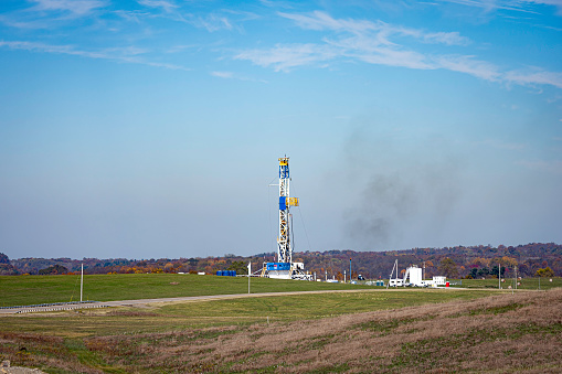 Harrison County, Ohio, USA - October 23, 2022:  Illustrative editorial image of a natural gas oil well in Harrison County in eastern Ohio in October. These wells utilize the controversial practice of fracking in the economically down-turned areas of the Ohio Valley region.