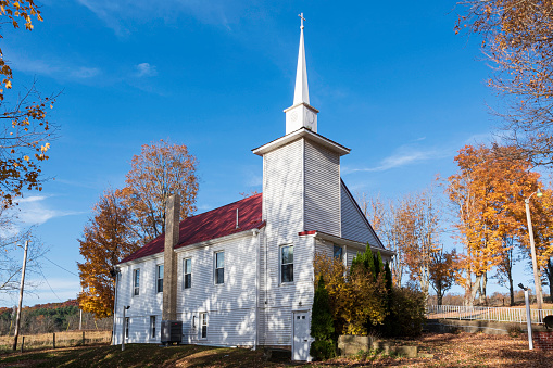 Church near Burlington, Vermont surrounded by autumn foliage.