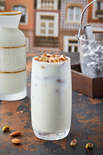 Rich Dry Fruit Lassi served in glass isolated on table top view of punjabi culture