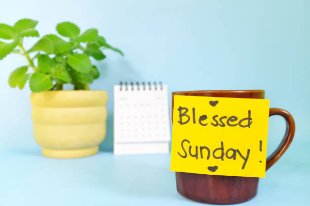 istock Blessed Sunday concept. Selective focus of coffee cup with bright yellow paper note and written message. 1444923457