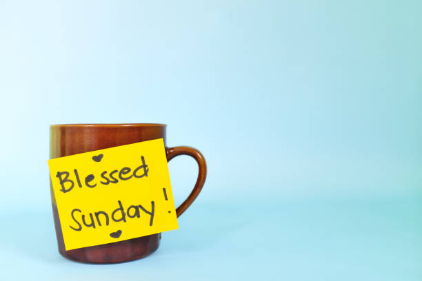 istock Blessed Sunday concept. Selective focus of coffee cup with bright yellow paper note and written message. 1444923462