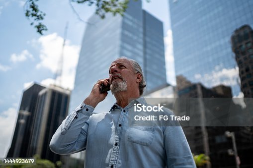 istock Senior man during a phone call at the financial district 1444923679