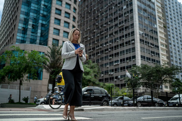 istock Mature woman using phone at the financial district 1444925310