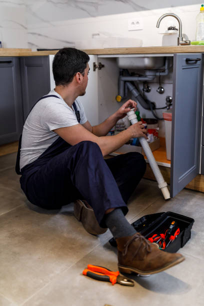 istock A young worker is repairing a faucet in the kitchen. 1444926370