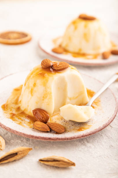 istock White milk jelly with caramel sauce on gray concrete, side view, selective focus. 1444926420