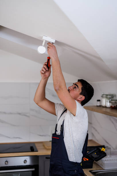 istock A young man is fixing a fire alarm with a screwdriver. 1444926550