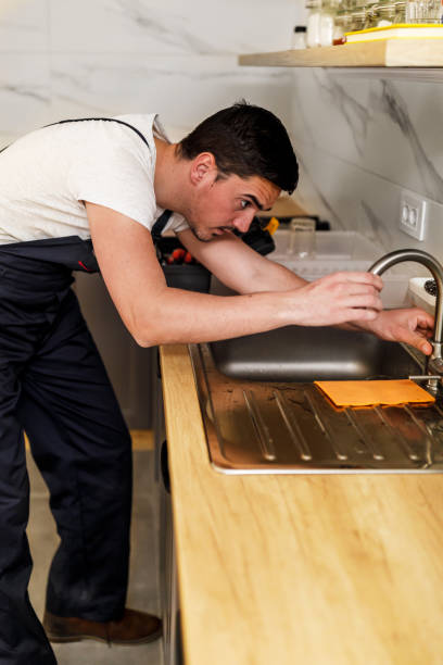 istock A younger man is working in the kitchen and fixing the faucet. 1444926850