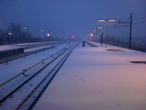 Foggy winter morning, scenery covered with snow. Waiting for the sunrise on Duivendrecht railway and subway station