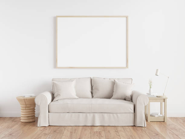 istock Interior poster mock up with horizontal white frames, beige sofa on wooden floor, wooden side table and table lamp in living room with white wall. 3d illustrations. 1444929356