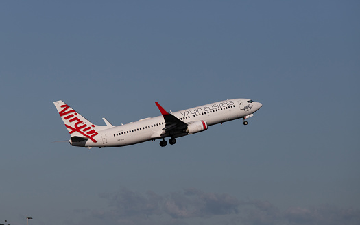 Sydney, Australia - November 20, 2022: Virgin Australia Boeing 737 flying on blue sky. Registration: VH-YIB.