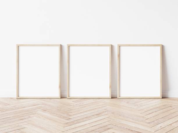 istock Three vertical wooden frame poster on wooden floor with white wall. 3 frame mock up. 3D illustration. 1444929671