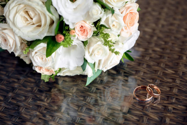 istock Wedding rings and bouquet on background 1444930266