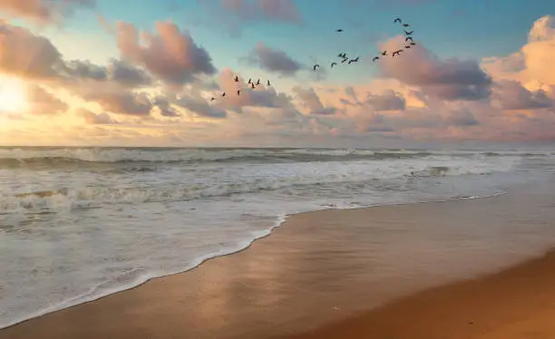 Puri sea beach at sunrise with moody sky at Puri, Odisha, India