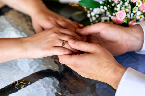 istock Wedding rings on hands close-up 1444931851