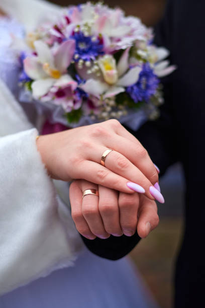 istock Wedding rings on hands close-up 1444931887
