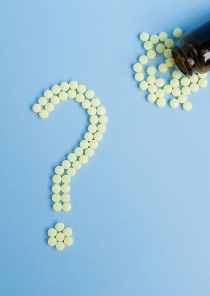 istock Assorted pharmaceutical medicine pills, tablets and capsules and bottle on blue background. Drugs and various narcotic substances. Copy space for text. Stock photo for design. 1444933301