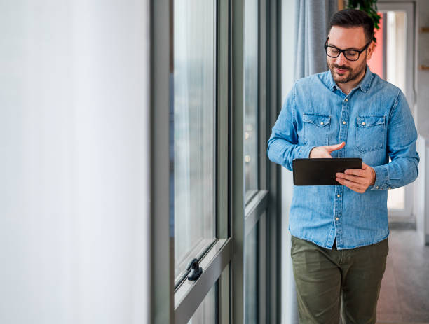 istock Professional young adult programmer, having an online meeting on his tablet 1444934340
