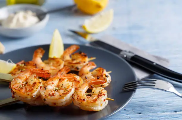 Grilled Shrimps with garlic and spices, with lemon on the side.