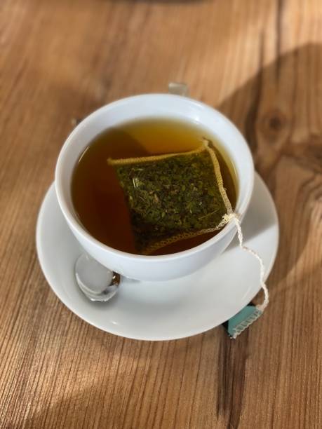 istock green tea in the cup on a wooden background. top view 1444936114