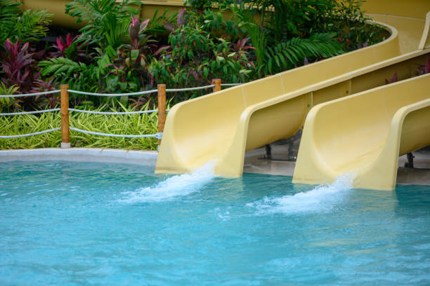 Water slides in the aqua park in tropical destination, copy space