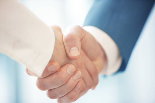 Friendly handshaking close-up stock photo