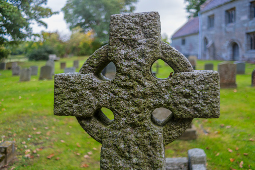 pre 1900 large granite cross against the Belfast Hills from a grave in the famous landmark Milltown Cemetery Belfast, which is the largest Catholic burial ground in Belfast and synonymous with Irish Republicanism.