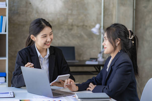 istock Two young asian accountants working on laptop computer and finance at workplace. Freelance business. Online marketing. ecommerce marketing ideas 1444946998
