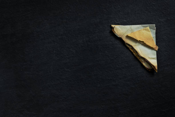 stack of old torn vintage letters on yellowed paper against black granite table. - writing manuscript ancient postcard imagens e fotografias de stock