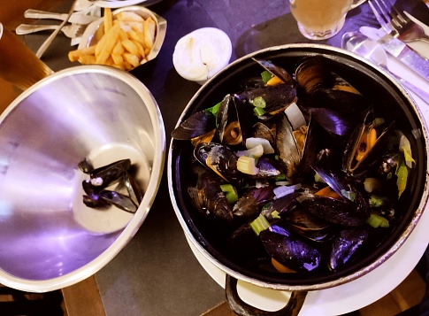 Traditional mussel dish with french fries chips at Brussels belgium