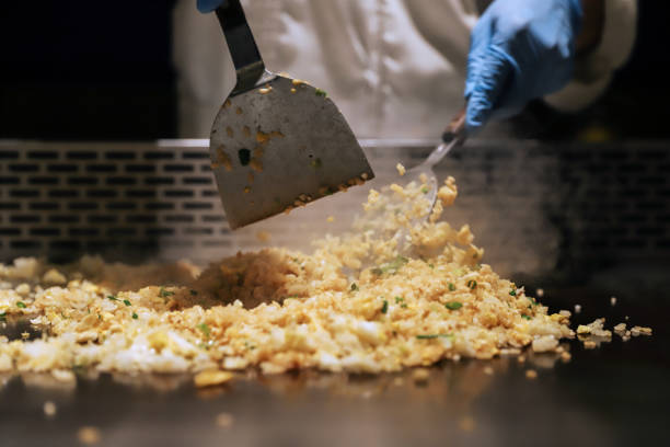 Teppanyaki style, fried rice. fried rice in Taiwan, Teppanyaki chef cooking in front of guests. Fried Rice stock pictures, royalty-free photos & images