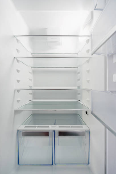 istock closeup of white clean refrigerator for store food, inside view 1444959009