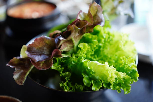 Freshly washed romaine lettuce in bowl Freshly washed romaine lettuce in bowl on table Romaine Lettuce stock pictures, royalty-free photos & images