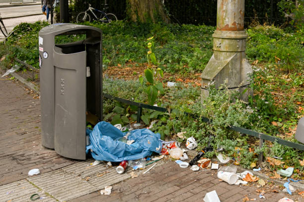 Amsterdam, Netherlands - August 2022:  Rubbish dumped next to a waste bin on a street near the city centre