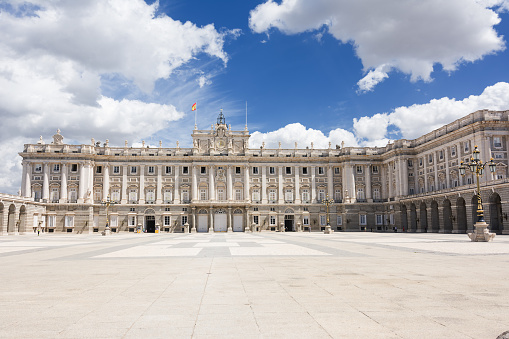 Madrid, Spain - June 20, 2022: Plaza of arms and royal palace of Madrid with blue sky and clouds
