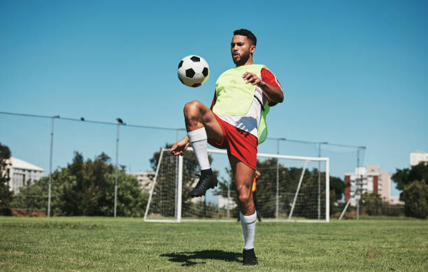 Soccer, football game and black man player on a sports field with a match ball. Fitness, training exercise and health cardio of an athlete workout exercising with energy and motivation in nature Soccer, football game and black man player on a sports field with a match ball. Fitness, training exercise and health cardio of an athlete workout exercising with energy and motivation in nature sports training drill stock pictures, royalty-free photos & images