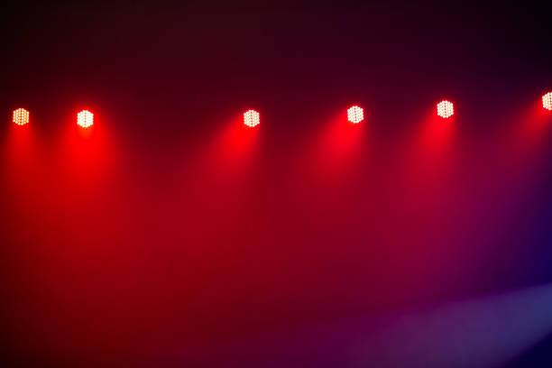 Red stage light from spotlights on a dark background.